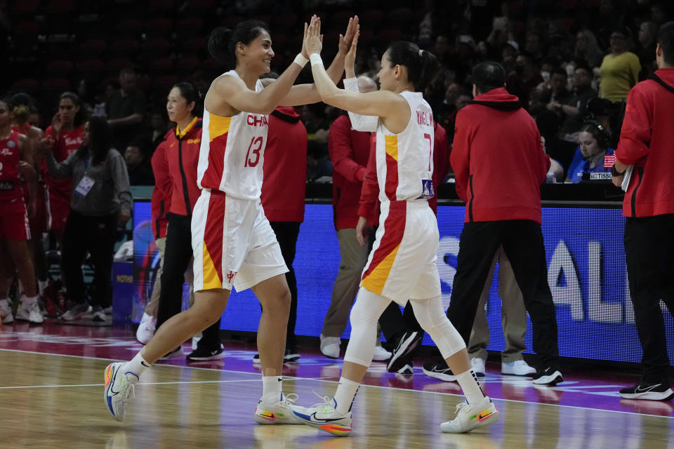 China's Dilana Dilixiati, left, and teammate Yang Liwei react after defeating Puerto Rico in their game at the women's Basketball World Cup in Sydney, Australia, Monday, Sept. 26, 2022. (AP Photo/Mark Baker)