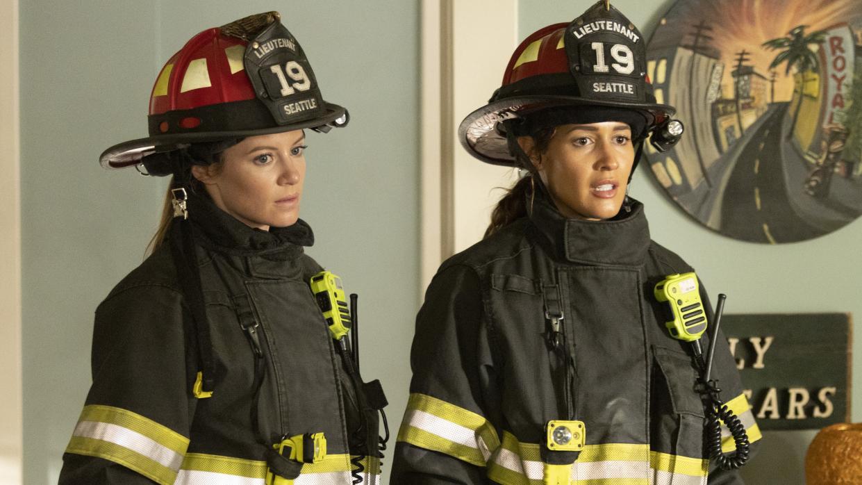  Maya and Andy side by side in their firefighter gear in Station 19 season 6. 