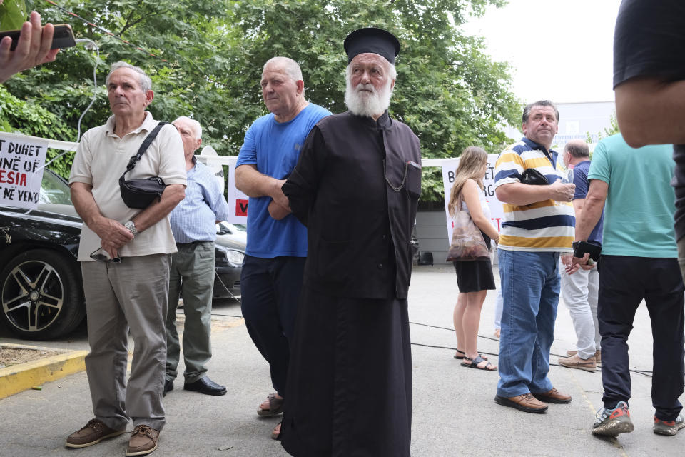 Supporters of Beleris stand outside a court in Tirana, Albania, on Tuesday, June 25, 2024. An Albanian appeals court on Tuesday upheld a two-year prison sentence for an elected mayor of the country's Greek minority, in a move expected to further exacerbate tension with neighboring Greece. The appeals court declined to change the verdict of the court of first instance in March on Dhionisios Alfred Beleris, 51, who was imprisoned on charges of vote-buying in municipal elections last year.(AP Photo/Vlasov Sulaj)