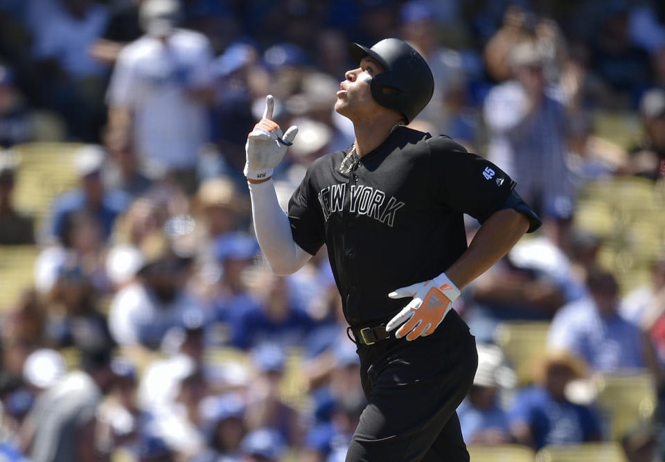 New York Yankees' Aaron Judge celebrates while crossing home plate after hitting a solo home run during the fourth inning of a baseball game against the Los Angeles Dodgers in Los Angeles, Saturday, Aug. 24, 2019. (AP Photo/Kelvin Kuo)