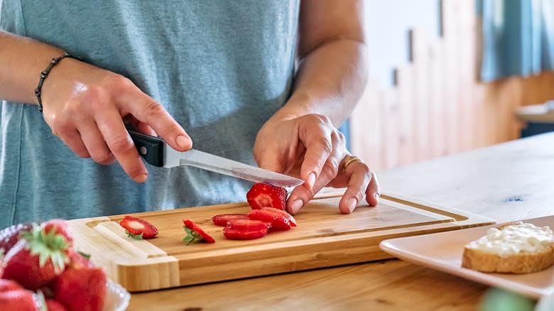 woman slicing strawberries