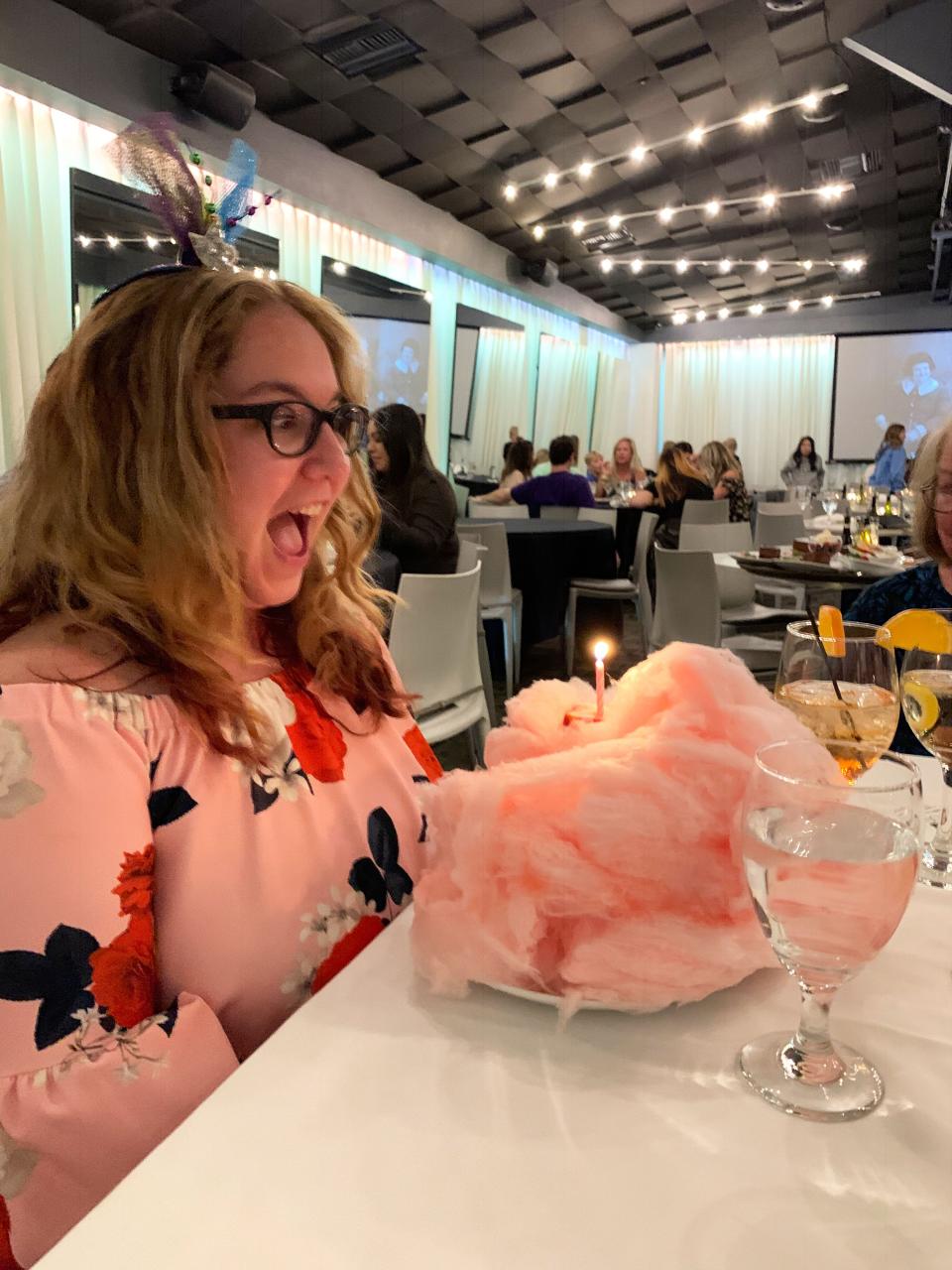 jamie blowing candle out of cotton candy tower at lulu in palm springs