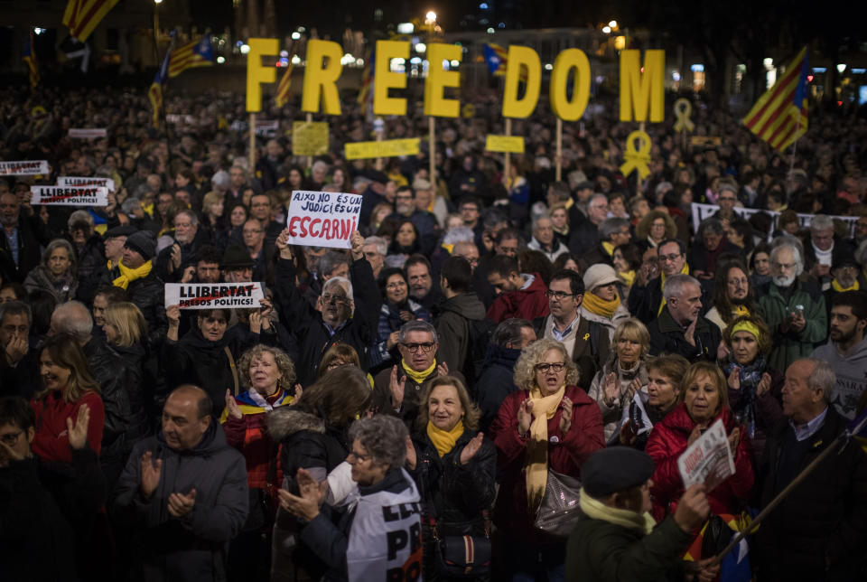 Pro independence demonstrators shout slogans during a protest in Catalonia square in Barcelona, Spain, Tuesday, Feb. 12, 2019. A sensitive trial against a dozen Catalan separatist politicians and activists got underway Tuesday in Spain's Supreme Court amid protests by pro-independence supporters and a highly volatile political environment. (AP Photo/Emilio Morenatti)