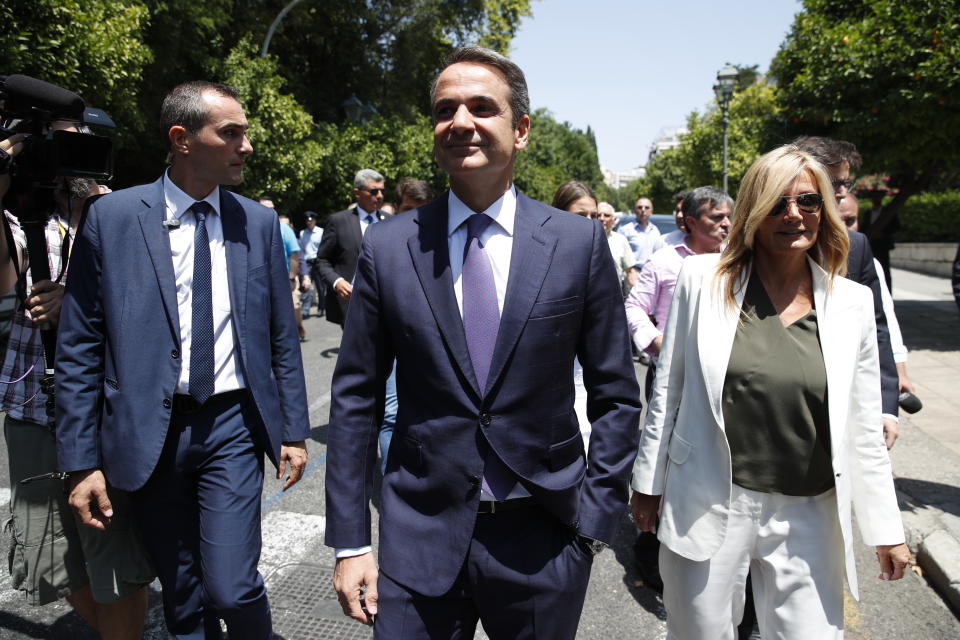 Greek opposition New Democracy conservative party leader Kyriakos Mitsotakis centre, walks with his wife Mareva, right in Athens, Monday, July 8, 2019. Mitsotakis was to be sworn in as Greece's new prime minister after a resounding win over left-wing Alexis Tsipras, who led the country through the tumultuous final years of its international bailouts. Mitsotakis' New Democracy party won 39.8% of the vote, giving him 158 seats in the 300-member parliament, a comfortable governing majority. (AP Photo/Thanassis Stavrakis)