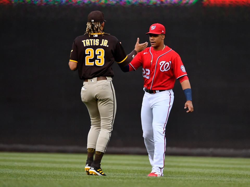 Fernando Tatis Jr. and Juan Soto greet before a July 2021 game in Washington.