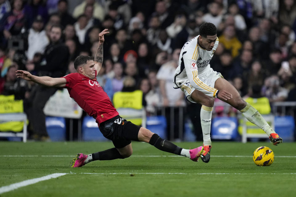 Mallorca's Giovanni Gonzalez tries to reach Real Madrid's Jude Bellingham during the Spanish La Liga soccer match between Real Madrid and Mallorca at the Santiago Bernabeu stadium in Madrid, Spain, on Wednesday, January 3, 2024. (AP Photo/Bernat Armangue)