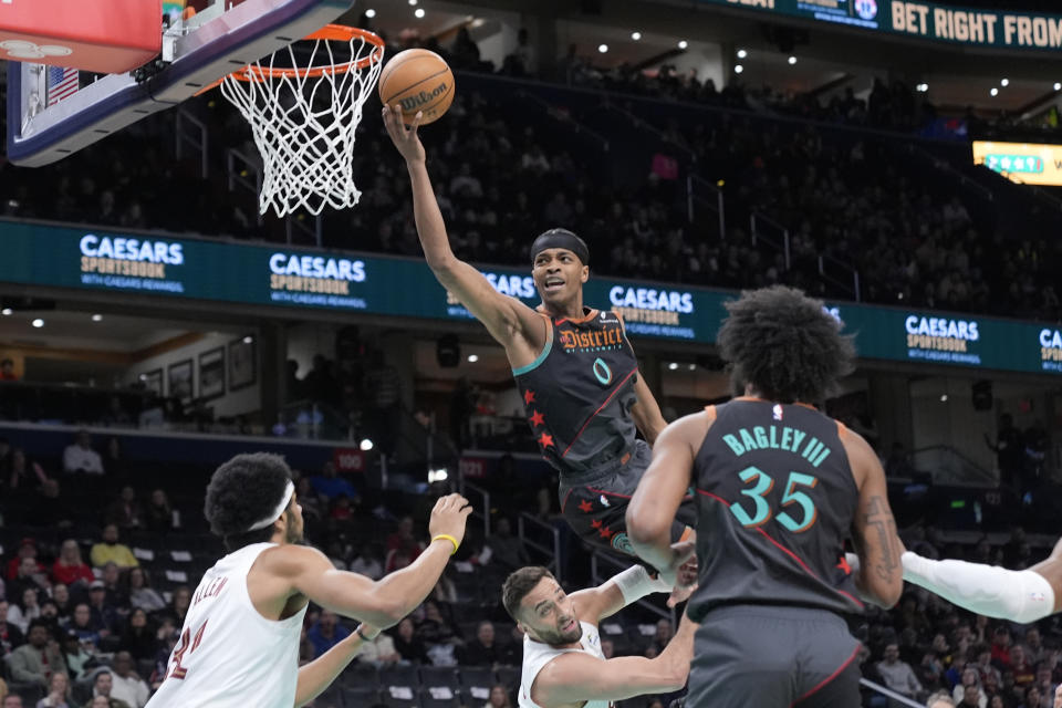 Washington Wizards guard Bilal Coulibaly (0) shoots and is charged with an offensive foul against the Cleveland Cavaliers during the first half of an NBA basketball game in Washington, Tuesday, Feb. 25, 2025. (AP Photo/Manuel Balce Ceneta)