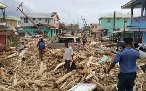 Damage caused the day before by Hurricane Maria in Roseau, Dominica - Credit: STR/AFP/Getty Images