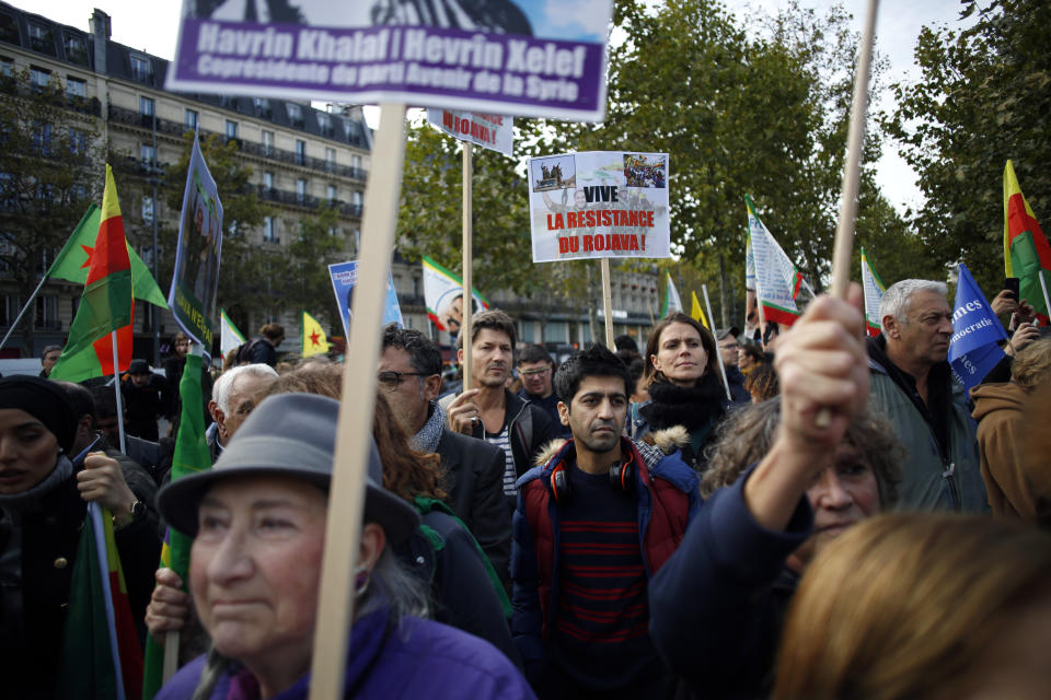 Protesters take part of a demonstration against Turkey's offensive in northern Syria, on Republique plaza in eastern Paris, Saturday, Oct. 19, 2019. Demonstrators warned that the offensive could allow Islamic State extremists to resurge. Kurdish forces being targeted by Turkey this week were crucial to the international campaign against IS extremists, who orchestrated several deadly attacks against France. (AP Photo/Thibault Camus)