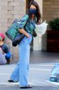 <p>Katie Holmes grabs a bouquet of flowers while out shopping on Tuesday in downtown N.Y.C.</p>