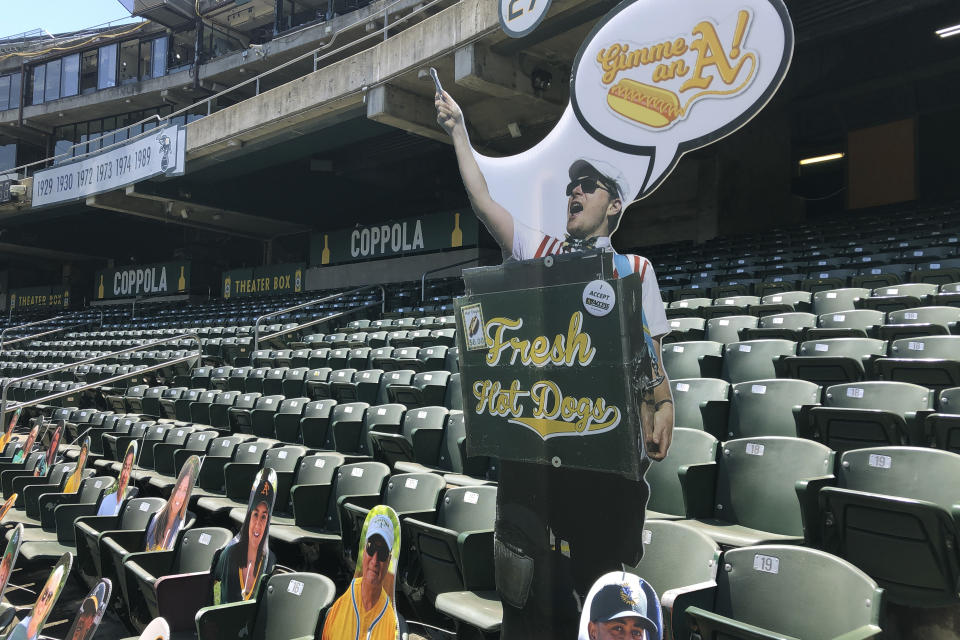 A cardboard hot dog vendors is displayed in the empty stands of the Oakland Coliseum during a baseball game between the Los Angeles Angels and the Oakland Athletics, Monday, July 27, 2020, in Oakland, Calif. (AP Photo/Ben Margot)