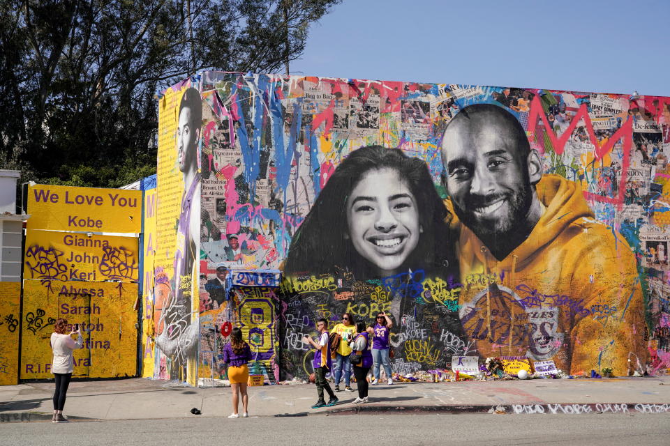 Fans gather around a mural of late NBA great Kobe Bryant and his daughter Gianna Bryant during a public memorial for them and seven others killed in a helicopter crash, at the Staples Center in Los Angeles, California, U.S., February 24, 2020. REUTERS/Kyle Grillot/File Photo     TPX IMAGES OF THE DAY     SEARCH 