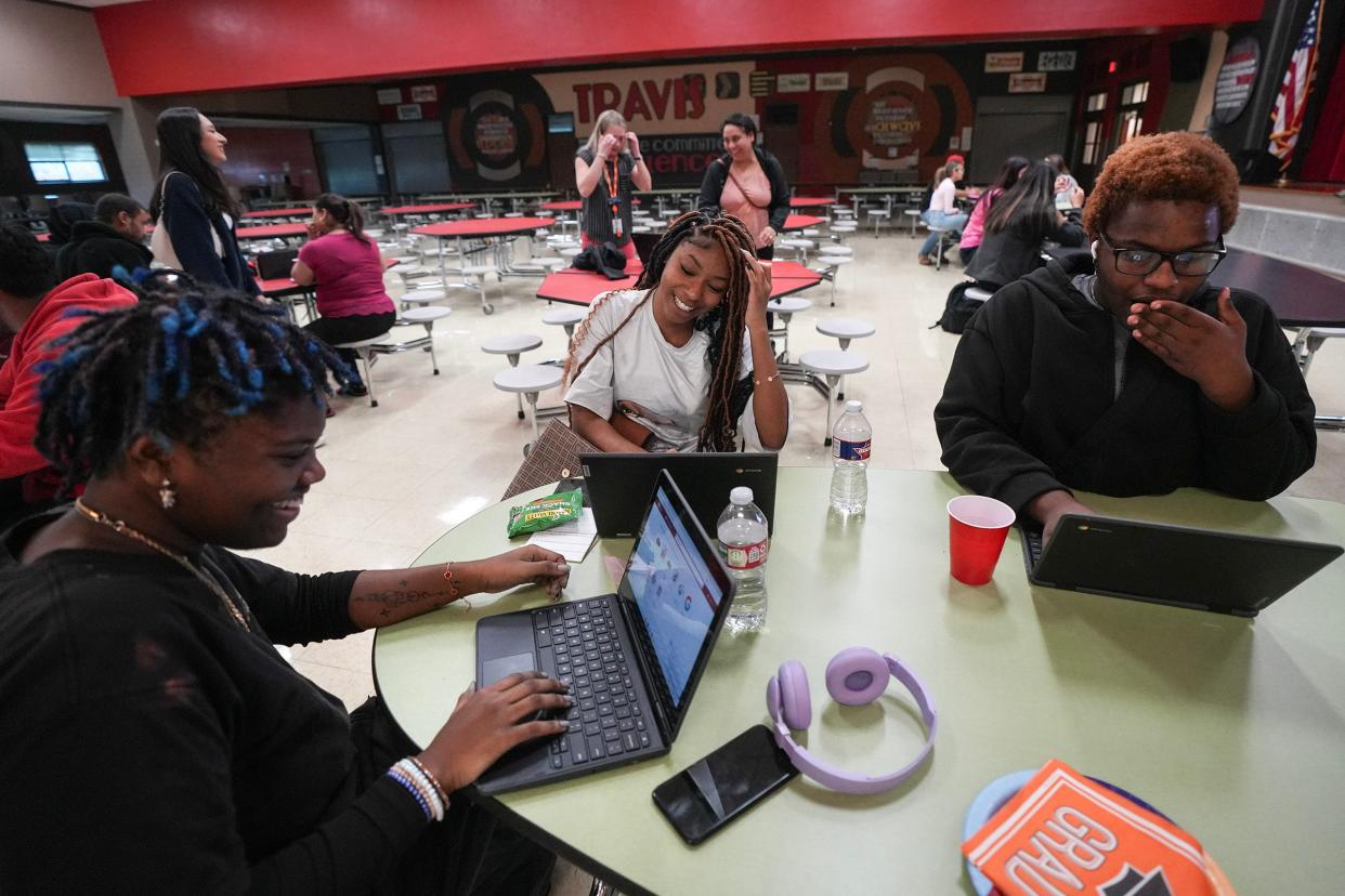 Seniors Maya Craft, Aleyia Fisher and Sean Powell learn about filling out FAFSA forms at an Opportunity Austin event last week at Travis Early College High School. The federal student financial aid forms were delayed this year by changes intended to streamline them.