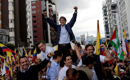 Guillermo Lasso, presidential candidate from the CREO party, greets supporters outside the electoral council headquarters, in Quito, Ecuador. REUTERS/Henry Romero