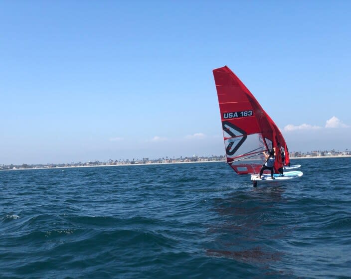 A competitor adjusts a sail in Long Beach Friday.