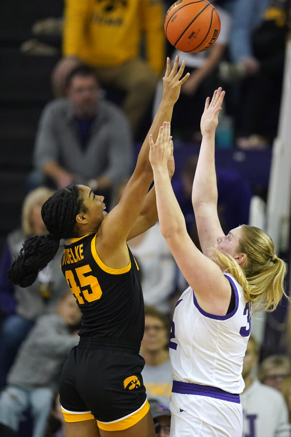 Iowa forward Hannah Stuelke (45) shoots over Northern Iowa center Rachael Heittola, right, during the first half of an NCAA college basketball game, Sunday, Nov. 12, 2023, in Cedar Falls, Iowa. (AP Photo/Charlie Neibergall)