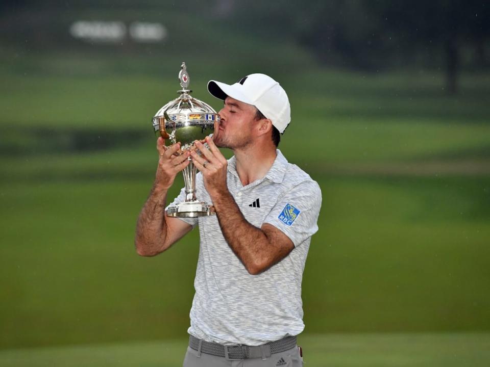 Nick Taylor kisses the trophy after winning the RBC Canadian Open at Oakdale Golf and Country Club in Toronto on Sunday.  (Minas Panagiotakis/Getty Images - image credit)
