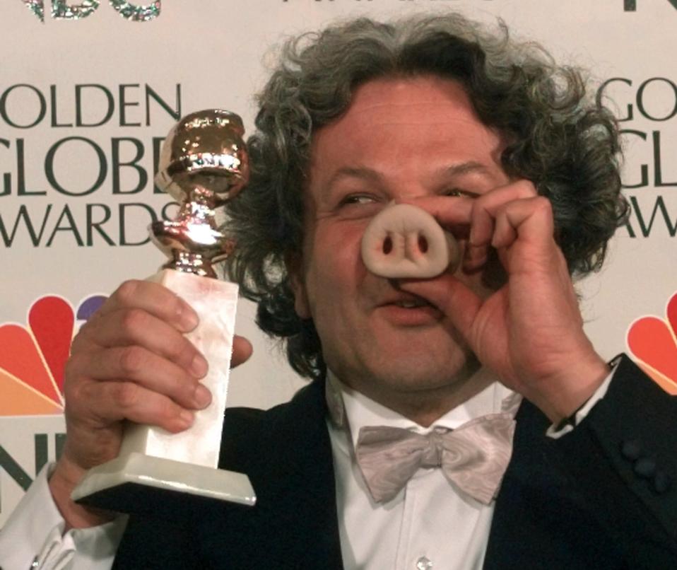 Producer George Miller sports a pig nose as he holds his award for Best Motion Picture - Musical or Comedy for "Babe" at the Golden Globe Awards, Sunday, Jan. 21, 1996, in Beverly Hills, Calif. (AP Photo/Mark J. Terrill)