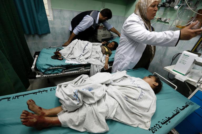 Palestinian doctors treat wounded children in a hospital following an airstrike by Israeli warplanes in Beit Lahia, northern Gaza Strip, on April 23, 2014