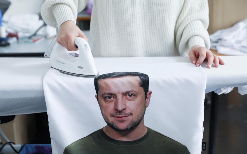 A woman works on a pillow cover with a portrait depicting Ukrainian President Volodymyr Zelenskiy, in Ceska Lipa, Czech Republic, March 17, 2022.