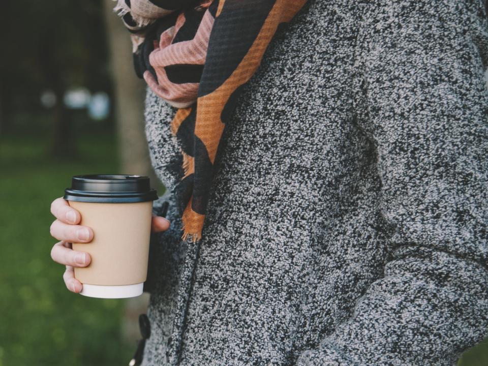 girl winter cold cozy holding coffee hot cocoa tea to go