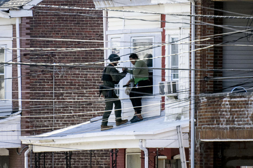 Police remove people from a home in Trenton New Jersey. (Joe Lamberti / AFP - Getty Images)