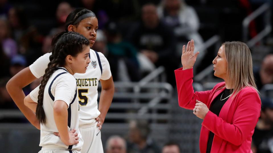 Marquette Blazers guard Jiselle Chabes (3) and Marquette Blazers forward Natalie Robinson (5) huddle with Marquette Blazers head coach Katie Collignon during the IHSAA girls basketball Class 1A state championship against the Lanesville Eagles, Saturday, Feb. 24, 2024, at Gainbridge Fieldhouse in Indianapolis. Lanesville Eagles won 51-43.