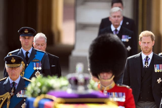 The King, the Prince of Wales and the Duke of Sussex follow the coffin the late Queen