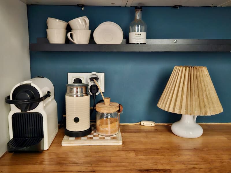 Coffee maker and lamp on a kitchen cabinet