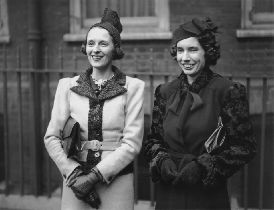 English socialite Freda Dudley Ward (1894 - 1983, left) and Lady Birkenhead (1913 - 1992, right) at the christening of Adrian Michael Berry at Gray's Inn Chapel, London, 19th October 1937. Adrian is the son of Lady Birkenhead's brother Michael Berry and his wife Pamela. (Photo by Keystone/Hulton Archive/Getty Images)