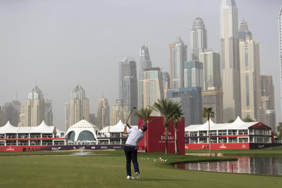 Lee Westwood of Britain hits an approach shot onto the green at the 18th hole during the round one of the Dubai Desert Classic golf tournament in Dubai, United Arab Emirates, Thursday, Jan. 24, 2019. (AP Photo/Neville Hopwood)