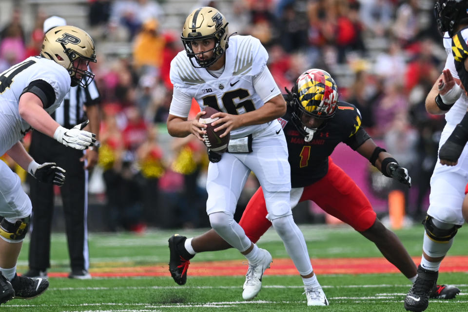 Oct 8, 2022; College Park, Maryland, USA; Purdue Boilermakers quarterback <a class="link " href="https://sports.yahoo.com/nfl/players/40138" data-i13n="sec:content-canvas;subsec:anchor_text;elm:context_link" data-ylk="slk:Aidan O’Connell;sec:content-canvas;subsec:anchor_text;elm:context_link;itc:0">Aidan O’Connell</a> (16) scrambles as Maryland Terrapins linebacker Jaishawn Barham (1) applies pressure during the first half at SECU Stadium. Mandatory Credit: Tommy Gilligan-USA TODAY Sports