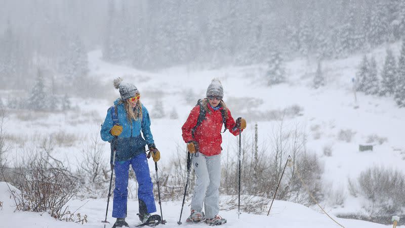 Anna Brinkworth, left, and her sister Megan Engelen return to their car after snowshoeing to Donut Falls in Big Cottonwood Canyon on Friday, Dec. 1, 2023.