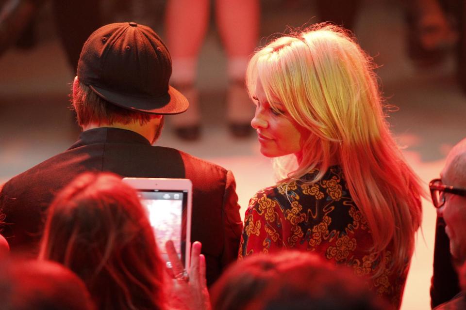 Pamela Anderson, right, attends Vivienne Westwood's ready-to-wear Spring/Summer 2014 fashion collection, presented Saturday, Sept. 28, 2013 in Paris. (AP Photo/Christophe Ena)