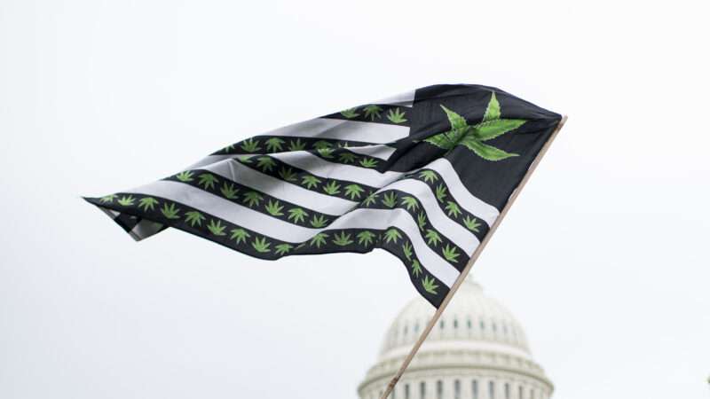 An American flag, with marijuana leaves incorporated, flies with the U.S. Capitol building in the background.