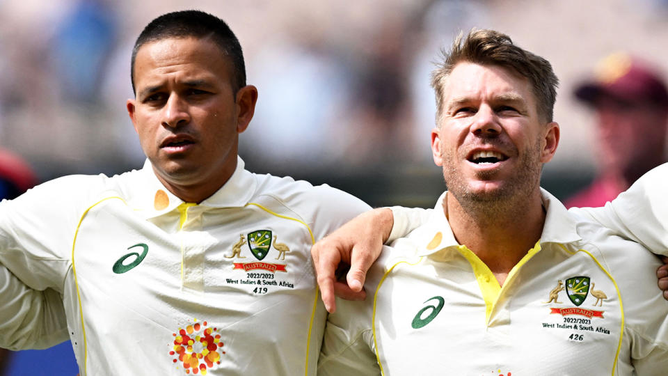 Usman Khawaja and David Warner sing the national anthem.