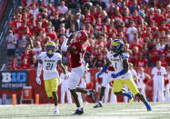 Rutgers wide receiver Bo Melton (18) catches a pass for a 57-yard gain as Delaware defensive back Justis Henley (21) and defensive back Kedrick Whitehead (1) defend during the first half of an NCAA college football game Saturday, Sept. 18, 2021, in Piscataway, N.J. (Andrew Mills/NJ Advance Media via AP)