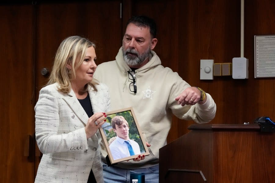 Oakland County prosecutor Karen McDonald stands next to Buck Myre, the father of Tate Myre, before his victim impact statement, Friday, Dec. 8, 2023, in Pontiac, Mich. Parents of students killed at Michigan’s Oxford High School described the anguish of losing their children Friday as a judge considered whether Ethan Crumbley, a teenager, will serve a life sentence for a mass shooting in 2021. (AP Photo/Carlos Osorio)