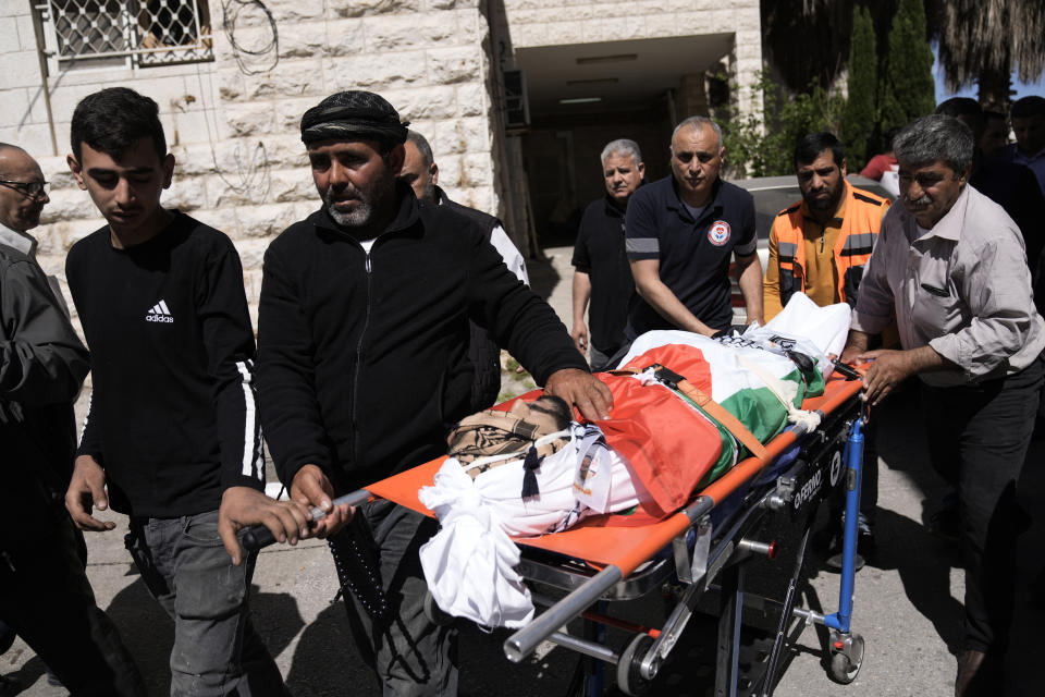 Ashraf Bani Jama' escorts the body of his son, Muhammad Bani Jama', who was shot and killed along with Abdul Rahman Bani Fadl in an Israeli settler attack earlier this week, according to Israeli Army Radio, during their funeral in the West Bank city of Nablus, Saturday, April 20, 2024. According to the Palestinian official state news agency, WAFA, the settlers were backed by the Israeli Army as they attacked the Khirbet at-Tawil area, near Nablus. Their bodies were handed over to Palestinian officials by Israel overnight. (AP Photo/Majdi Mohammed)