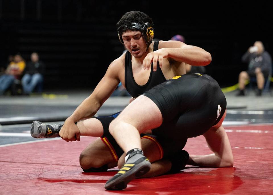 Elias Corona of Oakdale, left, and Turlock’s Elijah Watson grapple in the 215-pound title match during the Sac-Joaquin Section Masters Wrestling Championships at Stockton Arena in Stockton, Calif., Saturday, Feb. 17, 2024. Corona won 7-0.