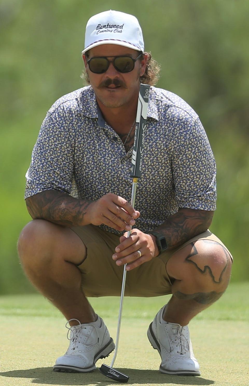 Cade Custer reads the green before putting during the final round of the Bentwood Country Club Men's Partnership golf tournament on Sunday, July 24, 2022.