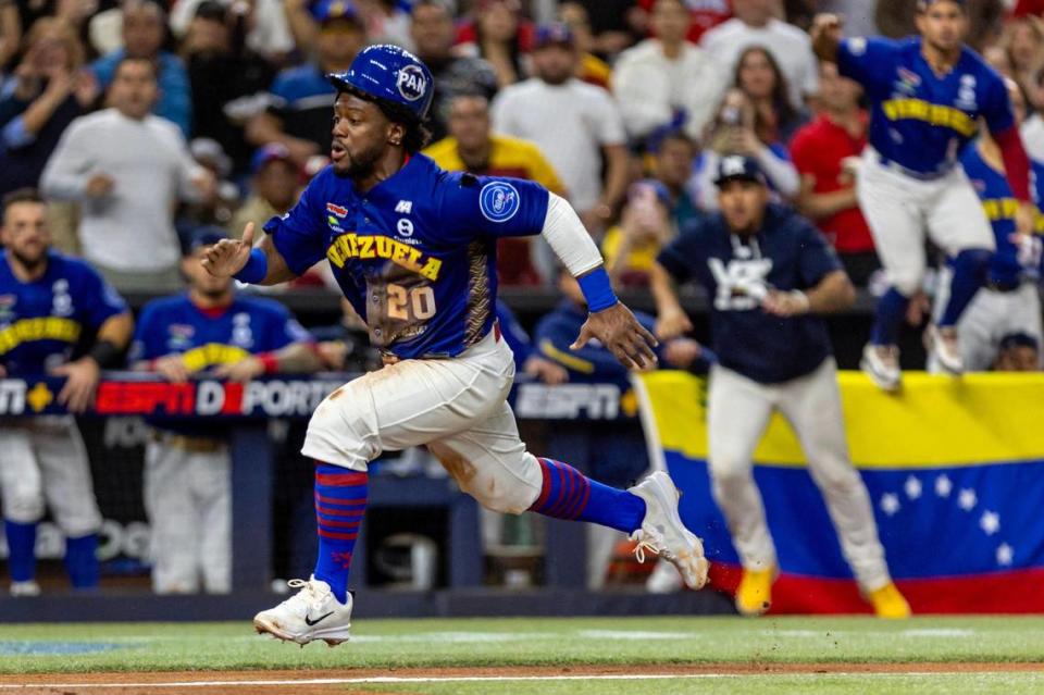 Venezuela base runner Odubel Herrera (20) runs towards home plate to score a run off a Alcides Escobar (2) sacrifice fly during the fourth inning of the Caribbean Series Championship baseball game against Dominican Republic at loanDepot park in Miami, Florida, on Friday, February 9, 2024.