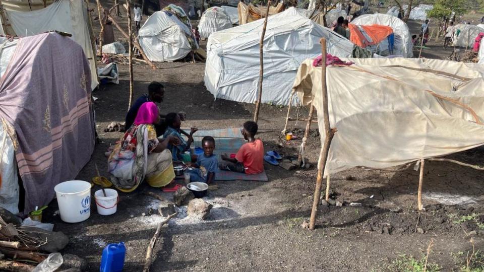 People look on near makeshift shelters, near Awlala Camp, Amhara region, Ethiopia