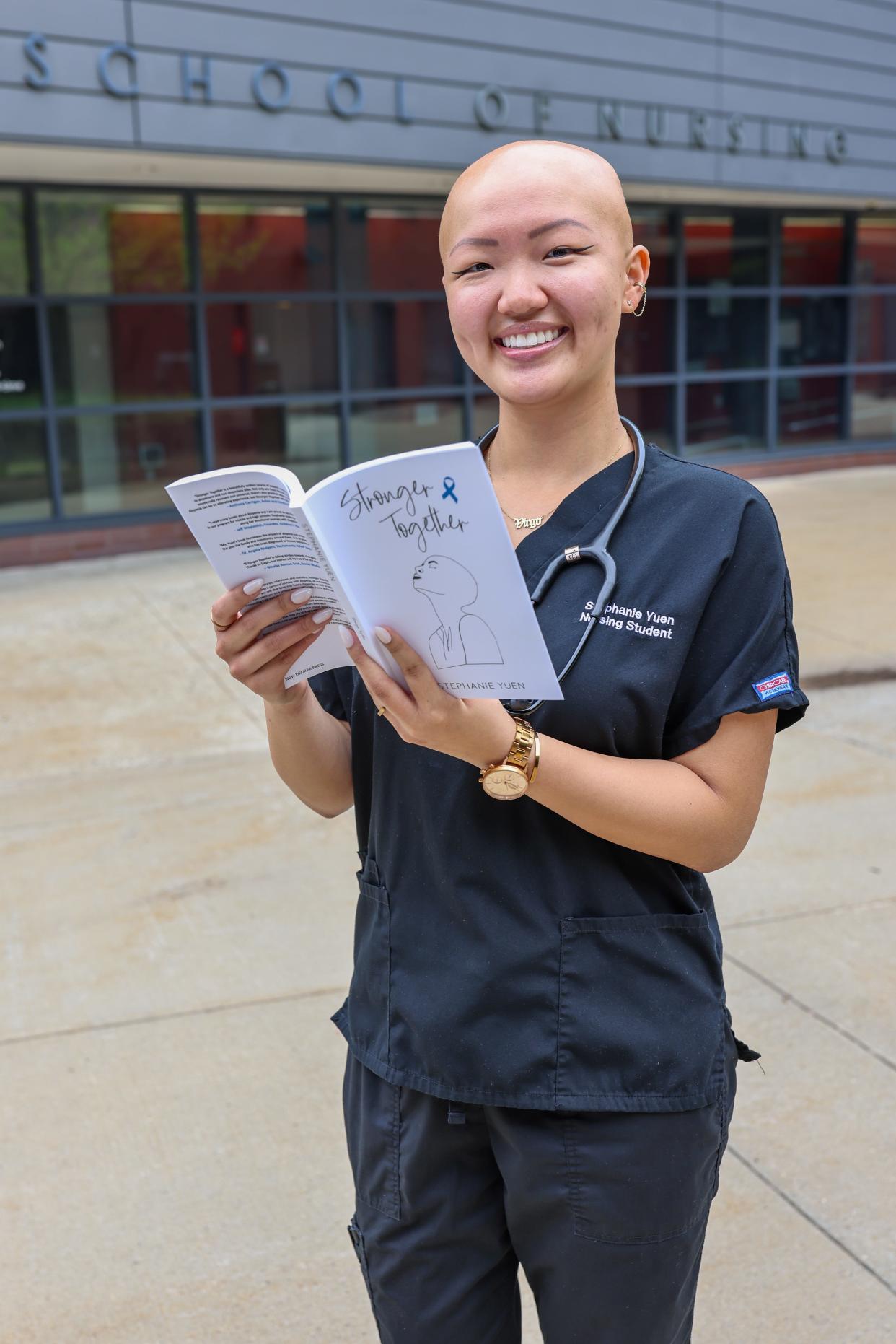 Stephanie Yuen holds a copy of her book "Stronger Together" outside Rutgers University's School of Nursing.