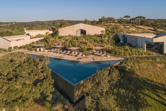 <p>João Guimarães/Courtesy of Pa.te.os</p> The grounds and infinity pool at Pa.te.os, a hotel in Portugal's Alentejo region.