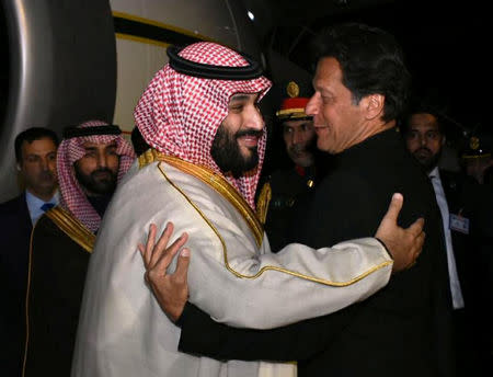 Pakistani Prime Minister Imran Khan (R) greets Saudi Arabia's Crown Prince Mohammed bin Salman on his arrival at Pakistan Air Force (PAF) Nur Khan Base in Rawalpindi, Pakistan February 17, 2019. Press Information Department (PID)/Handout via REUTERS