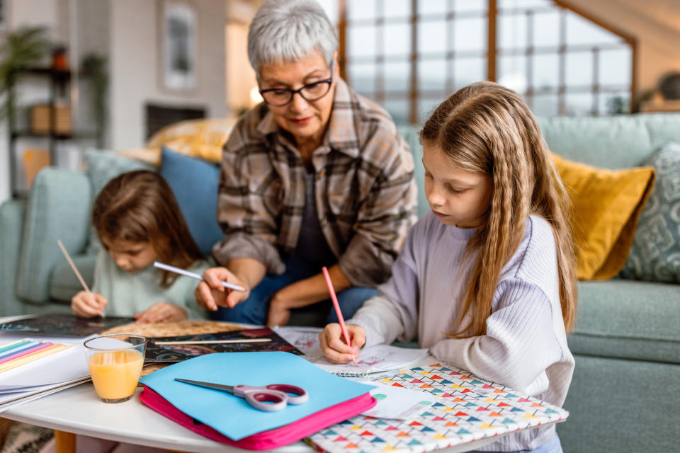 A woman drawing with kids