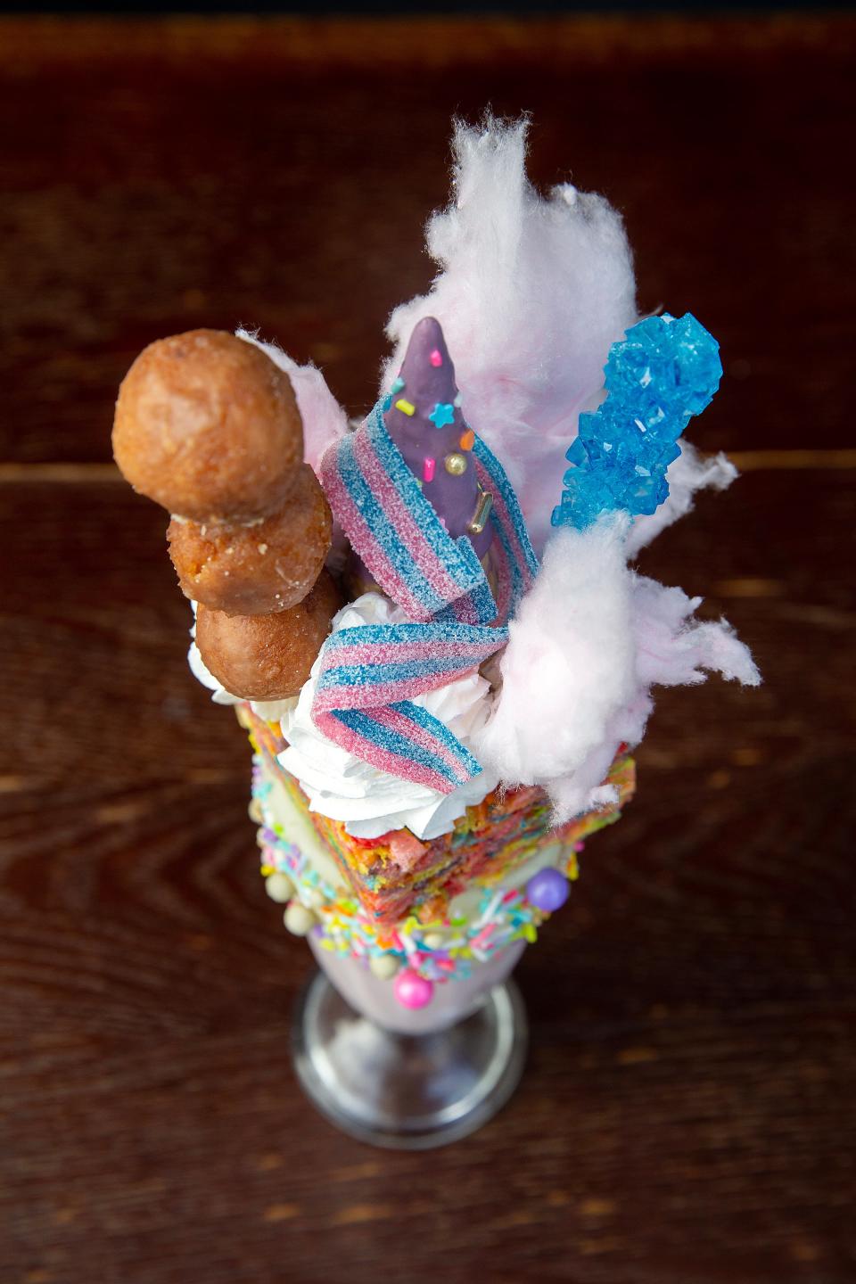Unicornation, a strawberry milkshake with sprinkles, donut holes, a Fruity Pebble crispy treat, sugar cone, whipped cream, rock candy and cotton candy, at The Loaded Spoon.
