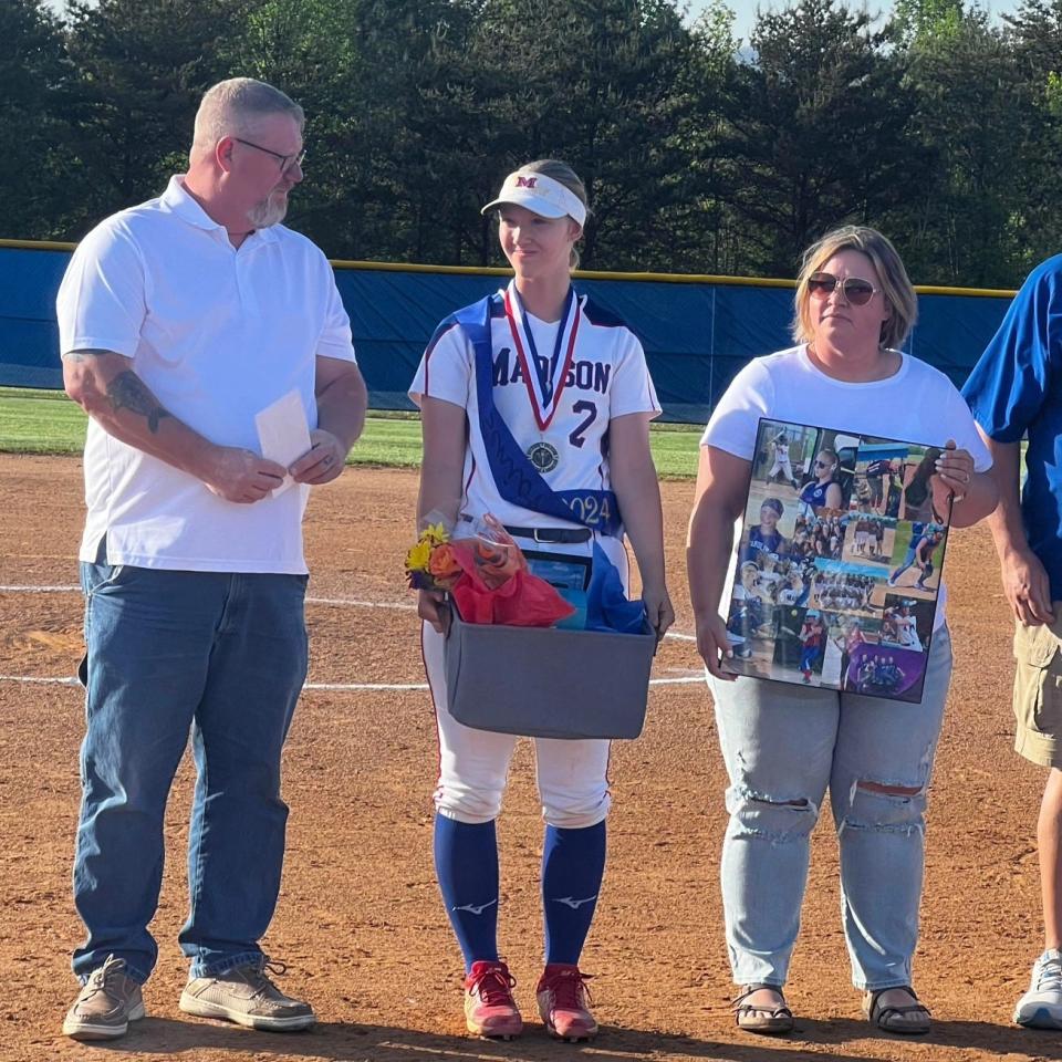 Madison High senior Preslea Harwood, who plays first base, is pictured here with her parents on senior night.