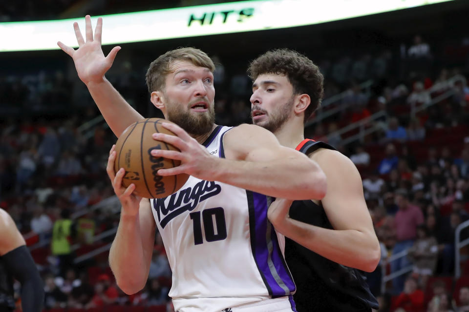 Sacramento Kings forward Domantas Sabonis (10) looks for a shot as Houston Rockets center Alperen Sengun defends during the first half of an NBA basketball game Saturday, Nov. 4, 2023, in Houston. (AP Photo/Michael Wyke)